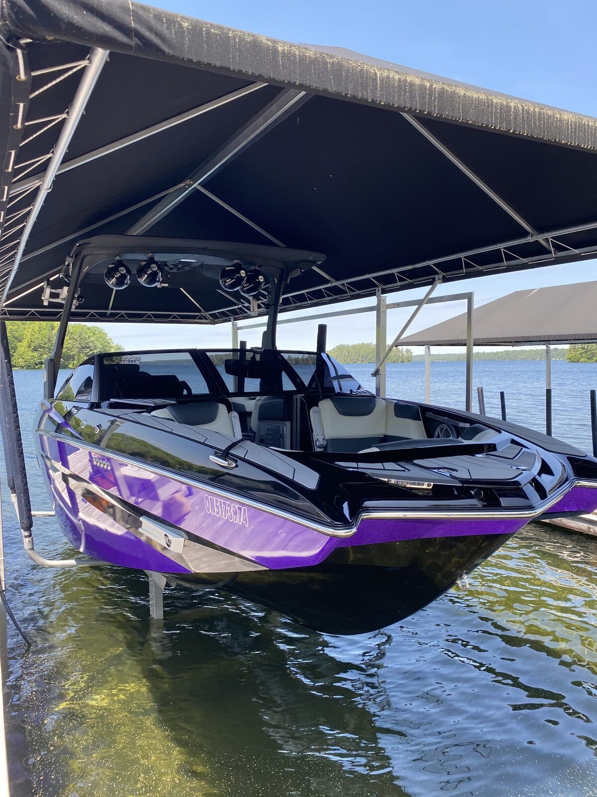Wakeboard boat on a covered dock